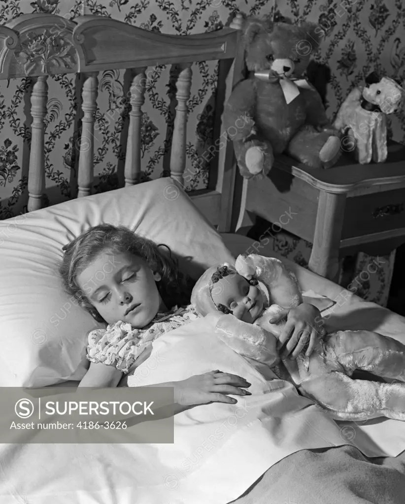 1950S 1960S Little Girl Sleeping In Bed With Arm Around A Doll