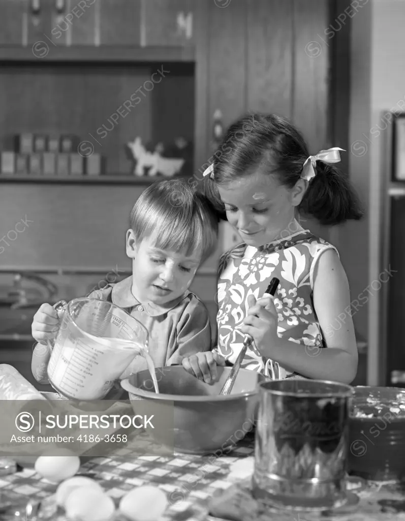 1960S Two Children Boy Girl Bowl Mixing Pouring Milk In Kitchen