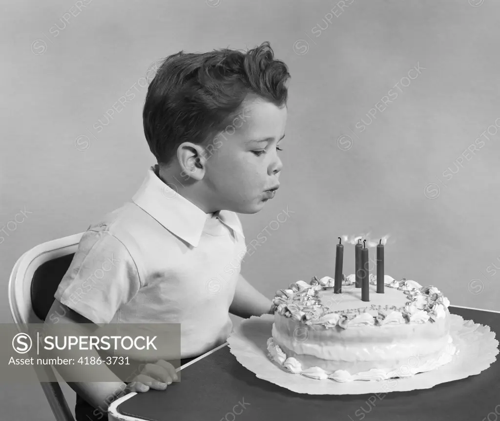 1950S Child Blowing Out Birthday Candles