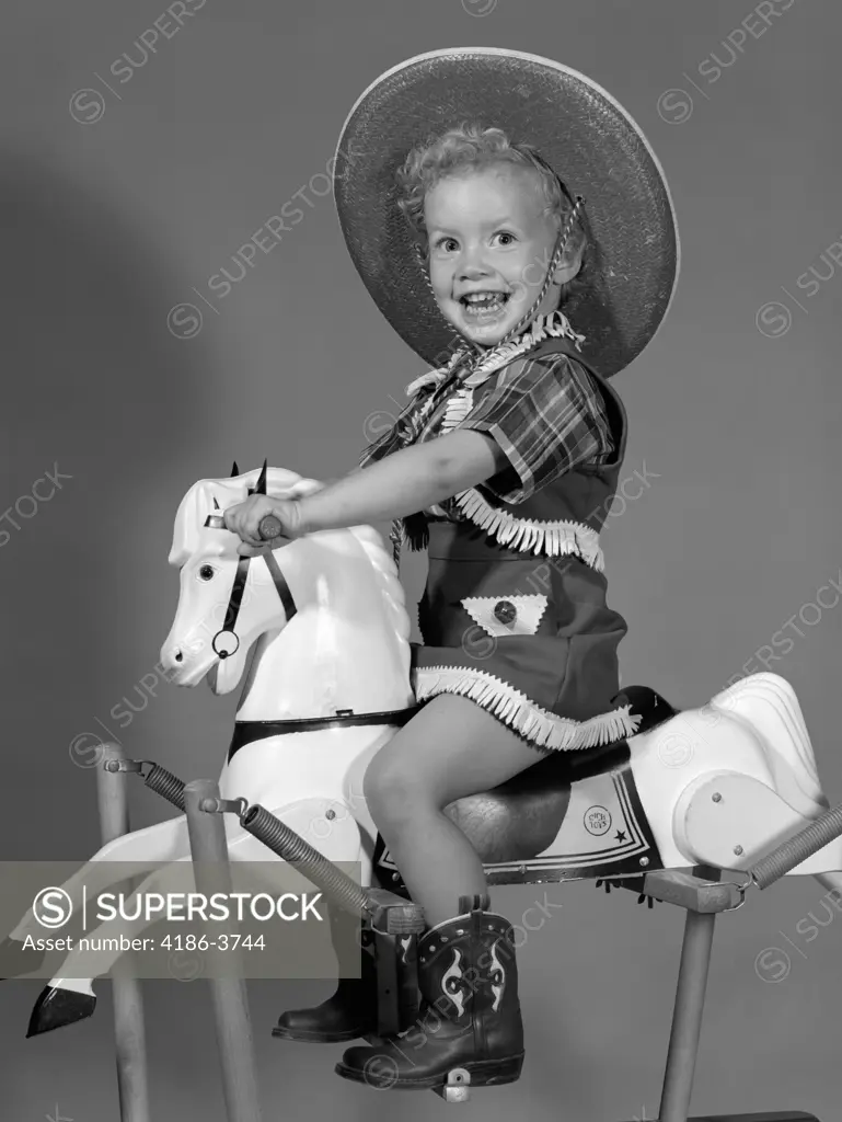 1950S Girl Dressed As Cowgirl Riding Rocking Horse