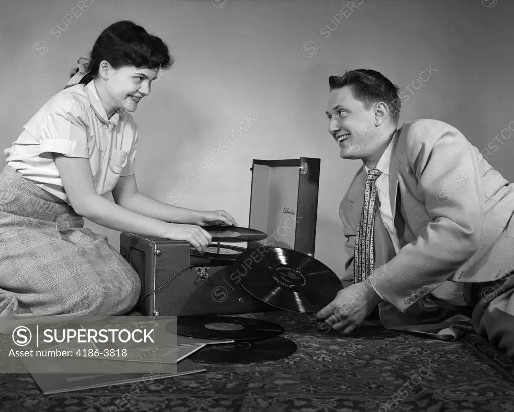 1950S Teen Couple Boy Girl Sitting Floor Playing Records On Portable Phonograph