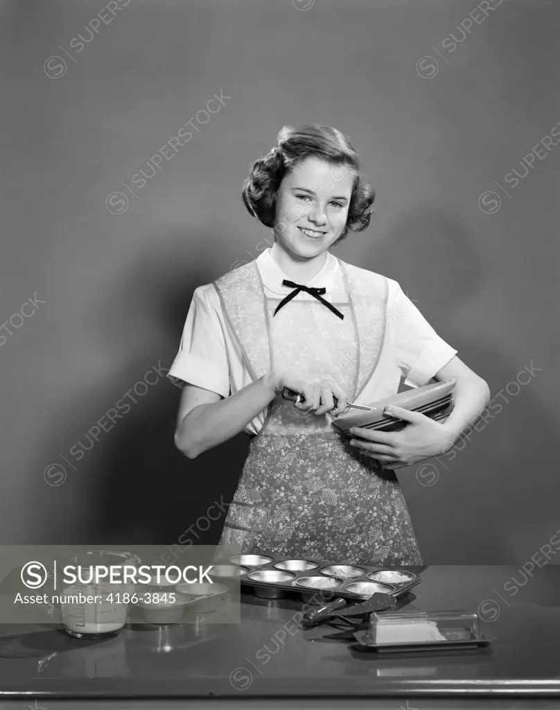 1950S Smiling Teen Girl Holding Mixing Bowl Wearing Apron Making Muffins