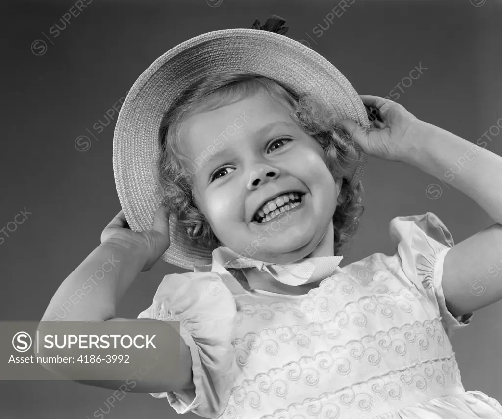 1950S Child Smiling Little Girl Wearing Pretty Dress And Straw Hat