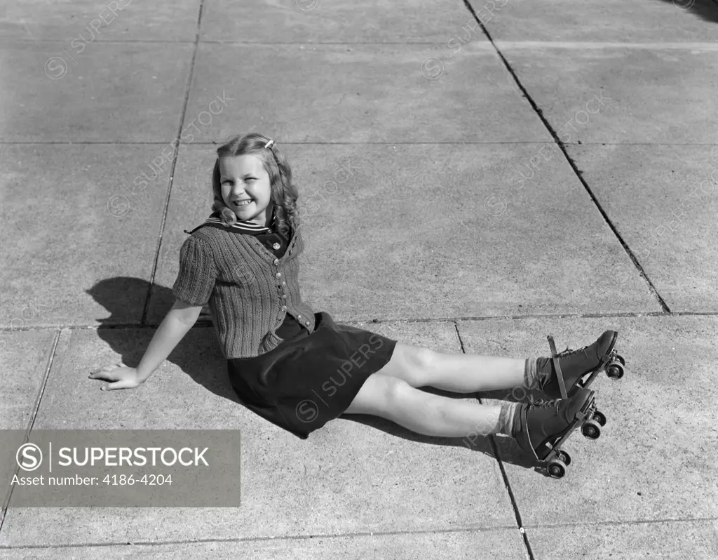 1940S Little Girl Sitting On Ground Wearing Roller-Skates