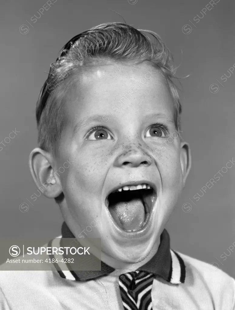 1960S Portrait Excited Boy With Mouth Wide Open Laughing