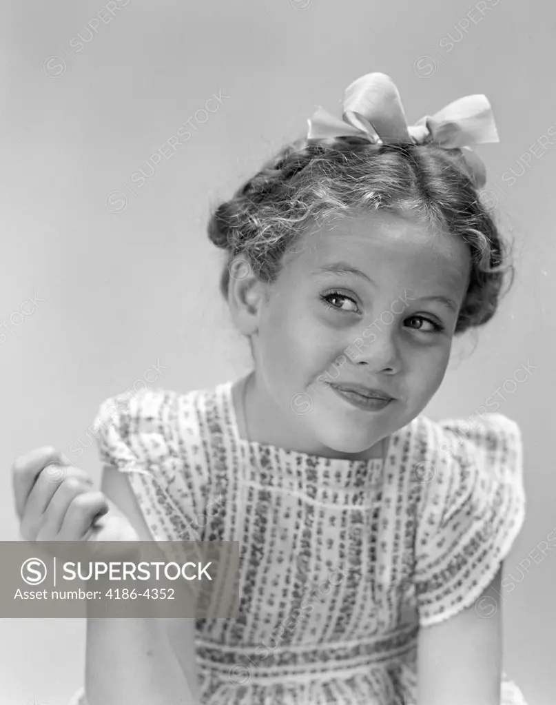 1940S Little Girl Smiling Smirking Looking Off To One Side