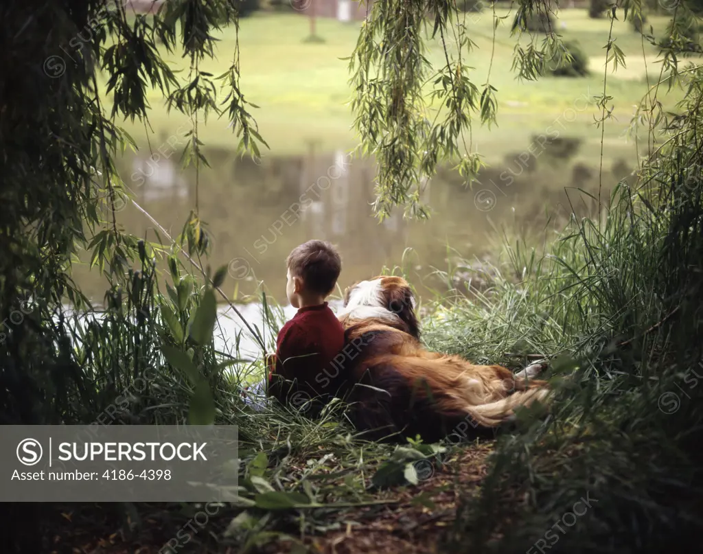 1960S 1970S Boy Fishing With His Dog By His Side