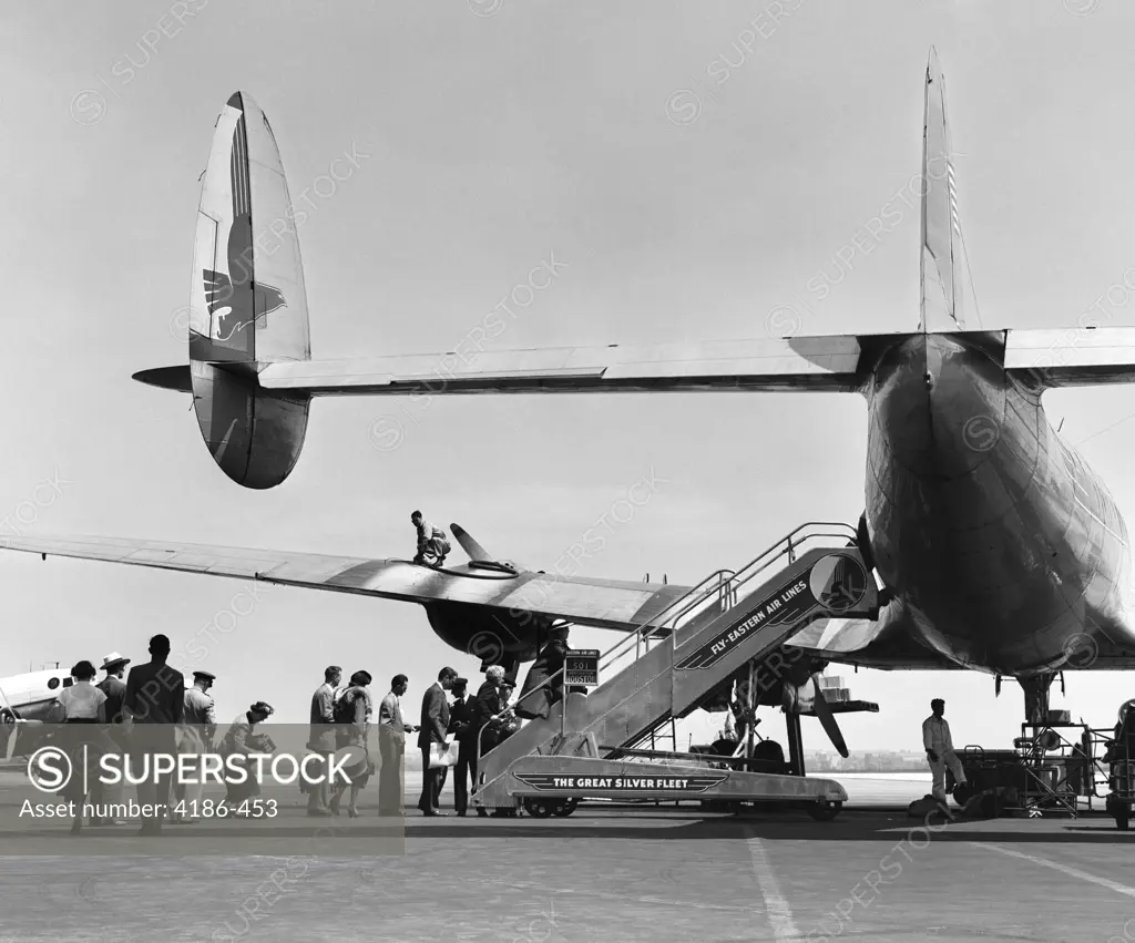 1950S People Boarding Constellation Style Airplane Double Tail Outdoor 