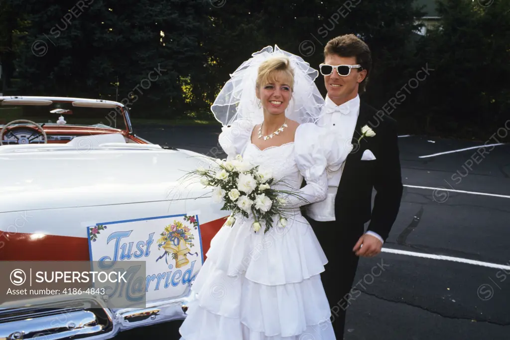 1991 Bride And Groom Standing Next To Vintage Convertible Ford Automobile