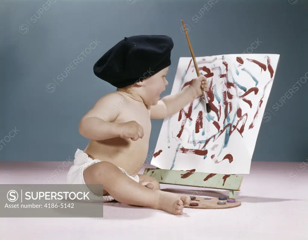 1960S Baby Artist Wearing Black Beret Sitting In Front Of Easel Painting