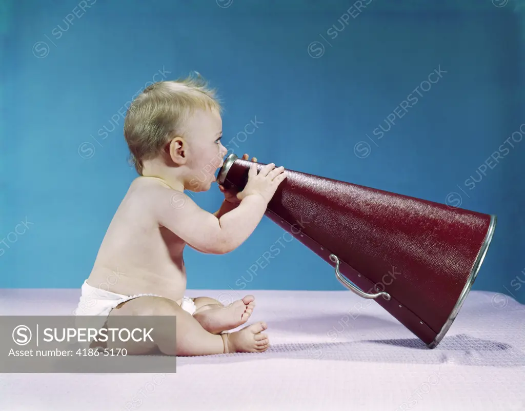 1960S Profile Of Seated Baby Shouting Yelling Speaking Into Big Megaphone