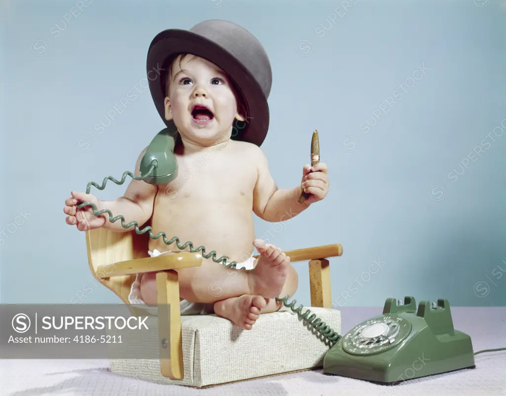 1960S Baby Boy Sitting Booster Chair Holding Cigar Wearing Hat Holding Telephone