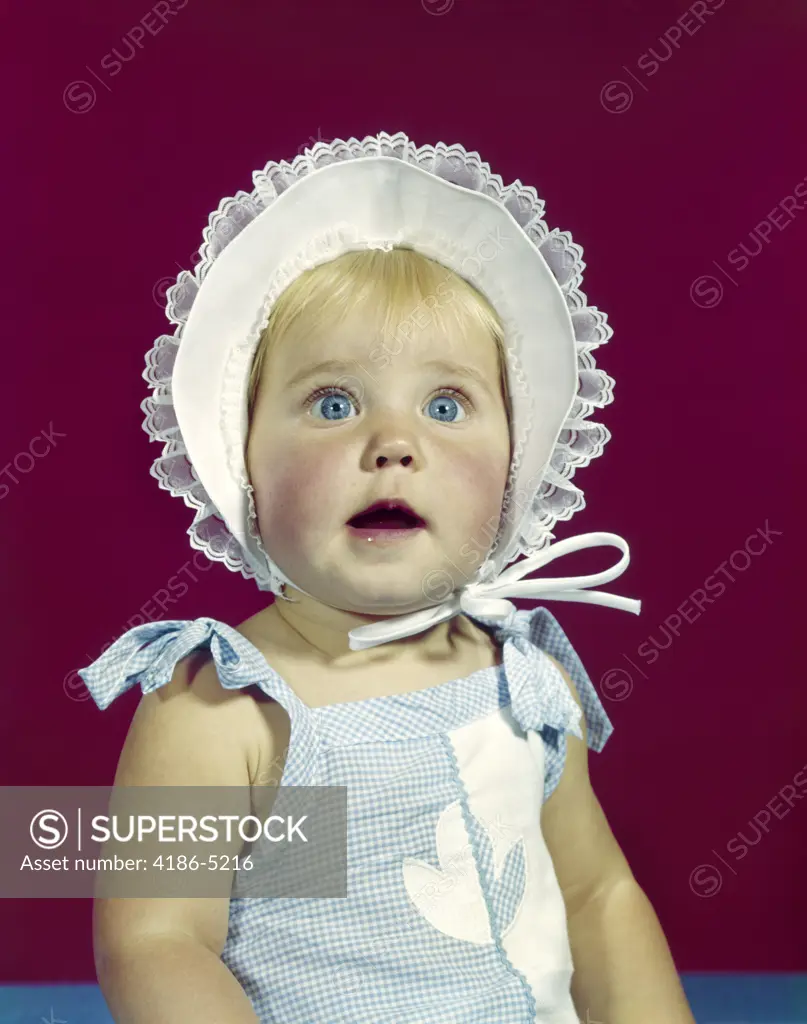 1960S Blonde Baby Blue Eyes Wearing Ruffled Bonnet Facial Expression Of Wonder  