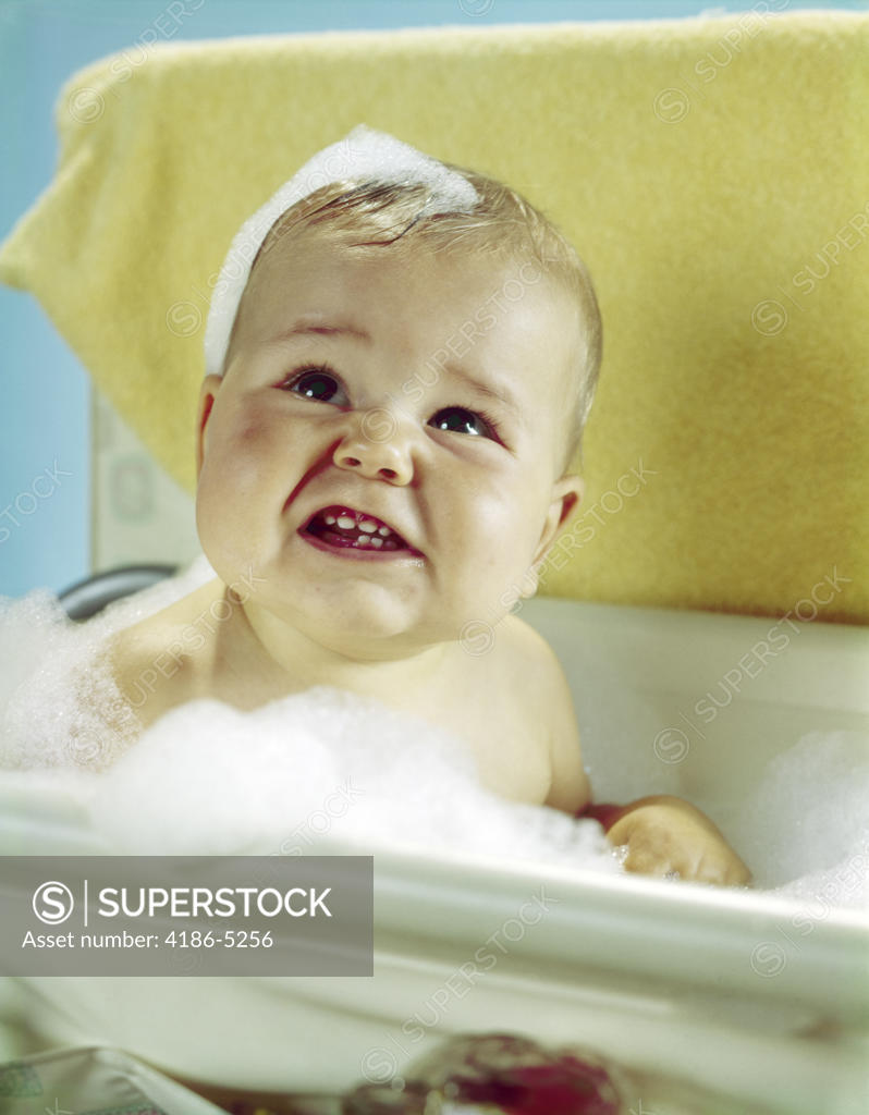 1960S Smiling Baby In Bath Looking Up - SuperStock