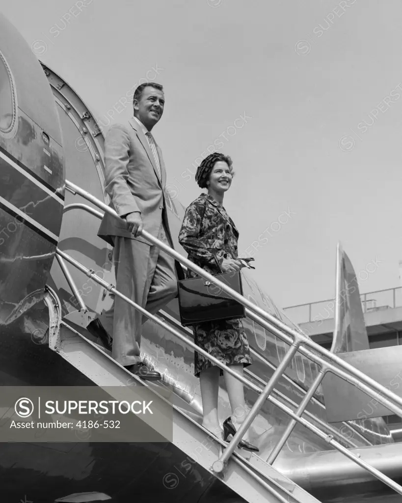 1950S Couple Exiting Plane Steps