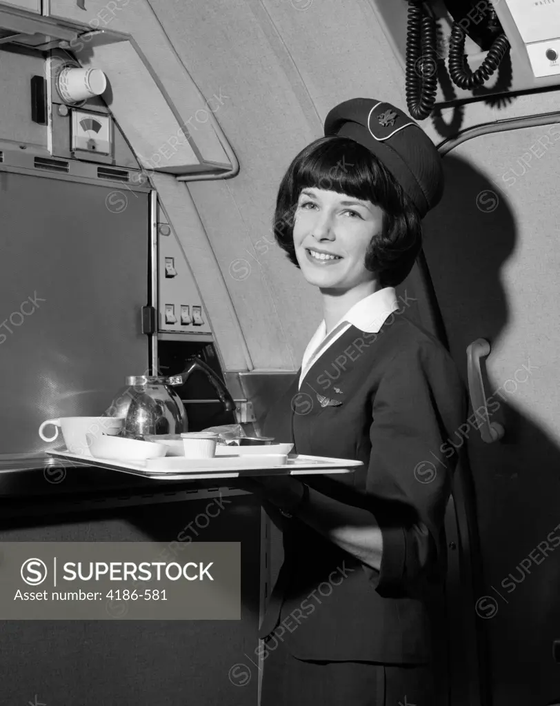 1960S Smiling Flight Attendant Holding Tray With Coffee Service Items