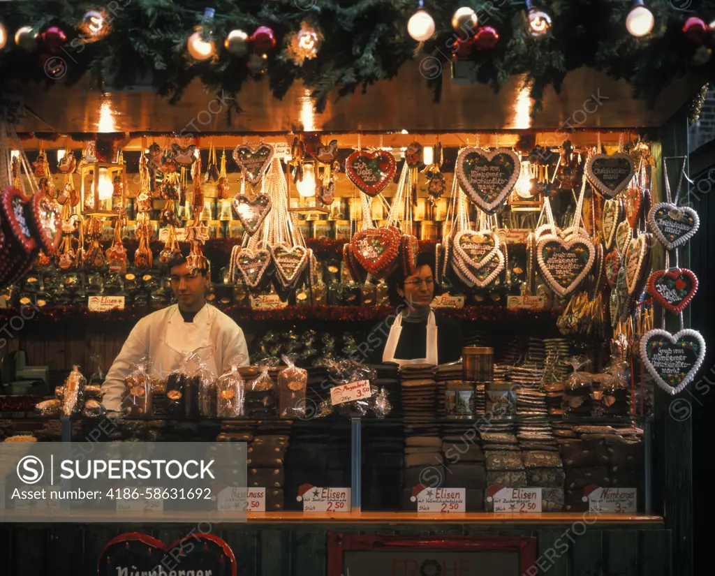 GERMANY COUPLE SELLING BAKED GOODS IN CHRISTMAS MARKET STALL