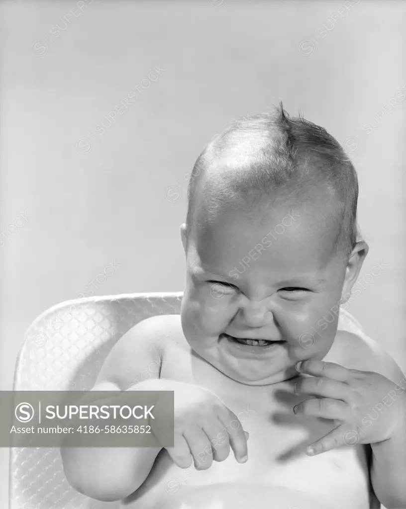 Adorable baby giggling in black and white photo - happiness and innocence