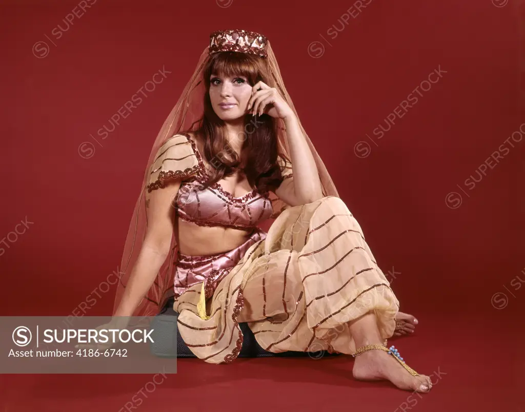 1960S Young Woman In Middle Eastern Harem Or Belly Dancer Costume Sitting On Floor Seductive Character