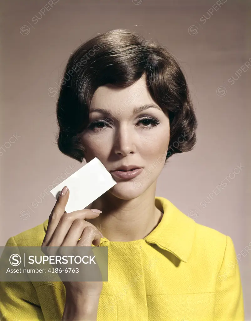 1960S Woman Holding Blank Business Card To Face