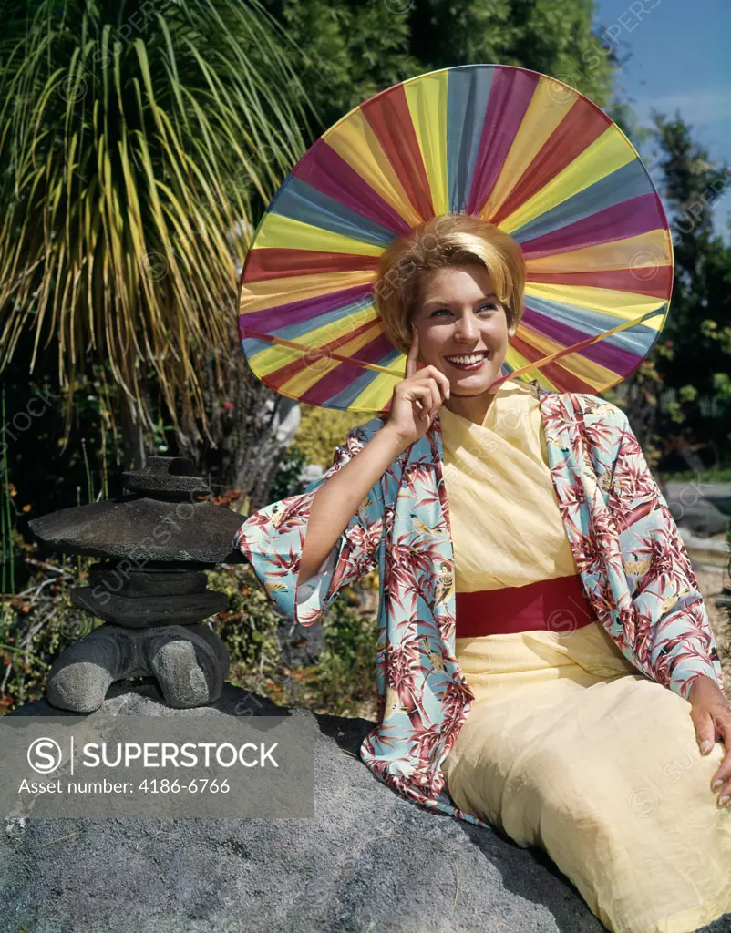 1950S Smiling Blond Woman Wearing Japanese Style Clothing And Funny Rainbow Colors Sun Hat