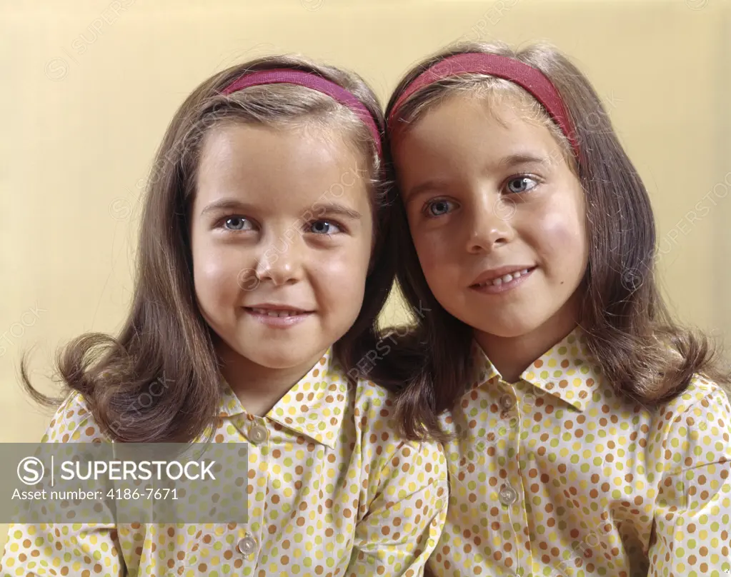 1960S Portrait Smiling Twin Sisters Wearing Identical Head Bands And Cotton Print Polka Dot Shirts