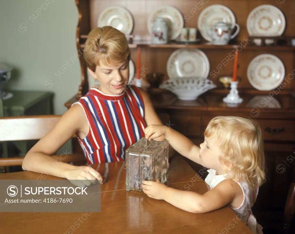 1970S Mother And Daughter With Piggy Bank