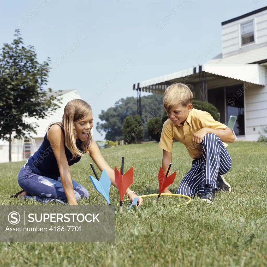 1970S Boy Girl Playing Lawn Darts Game In Backyard