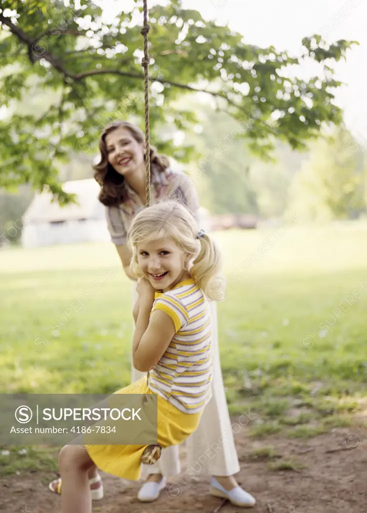 1970S Smiling Woman Mother With Girl Daughter Swinging Playing On Rope Swing