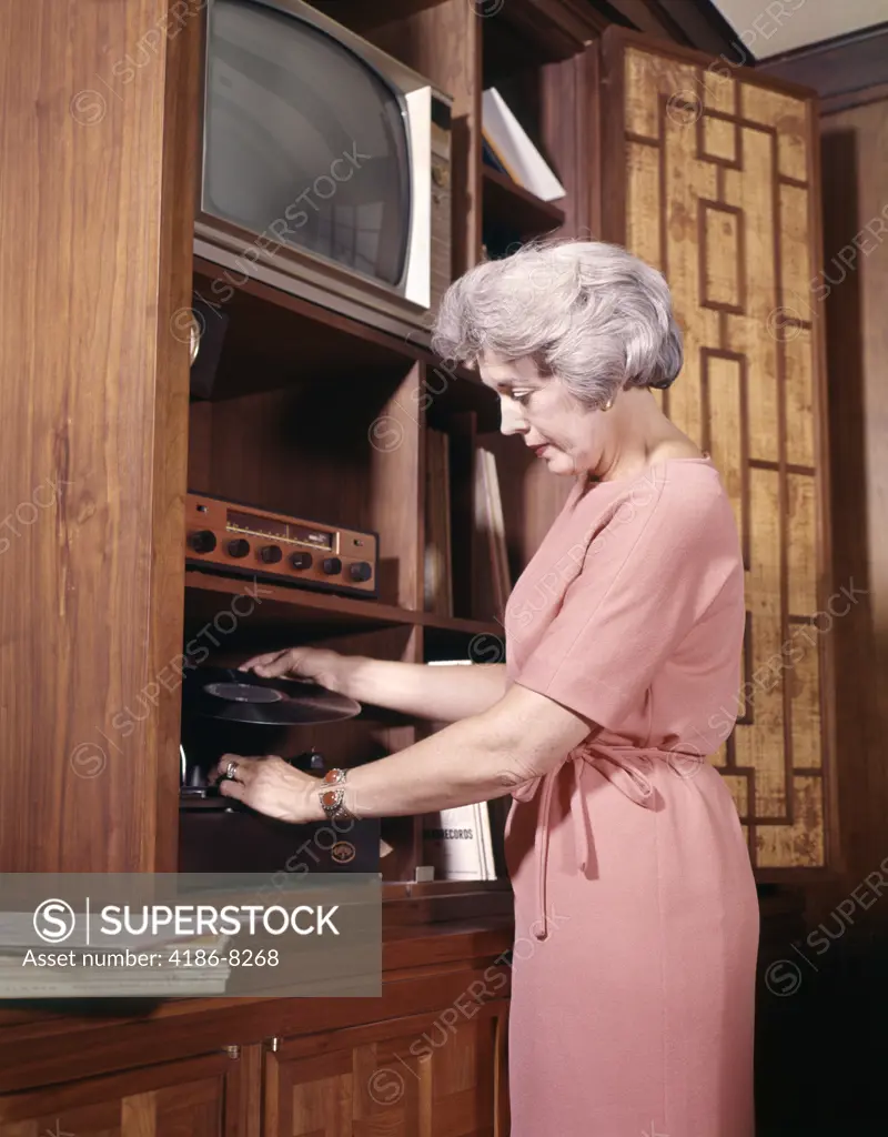 1970S Woman Playing Records Putting Record On Player