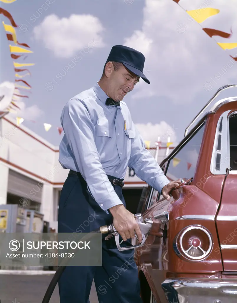 1950S 1960S Service Station Attendant With Gasoline Pump Hose Filling Gas Tank Of Automobile