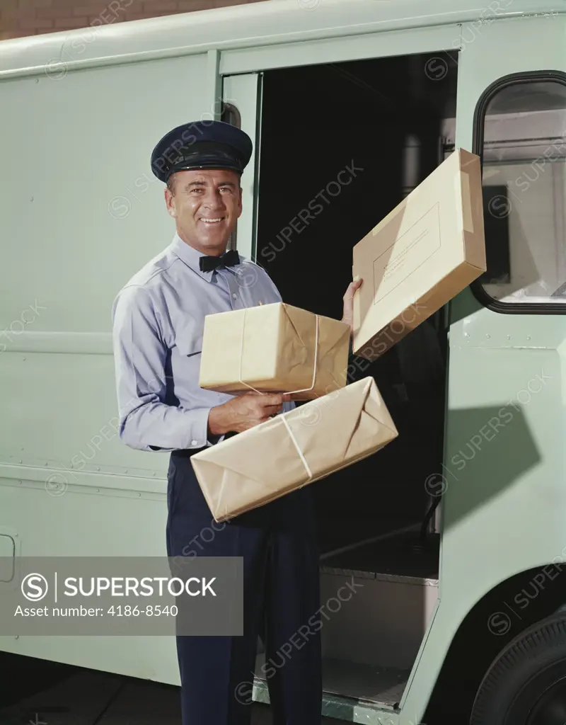 1950S 1960S Delivery Truck Driver Holding Packages    