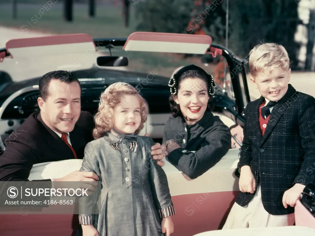 1950S Portrait Smiling Family Father Mother Son Daughter Sitting In Red White Convertible Automobile