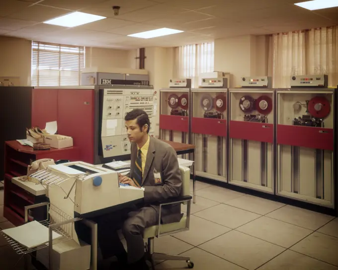 1960s 1970s MANGETIC TAPE DRIVES MAIN FRAME COMPUTER ROOM MAN AT CONSOLE IBM SYSTEM DATA INFORMATION STORAGE