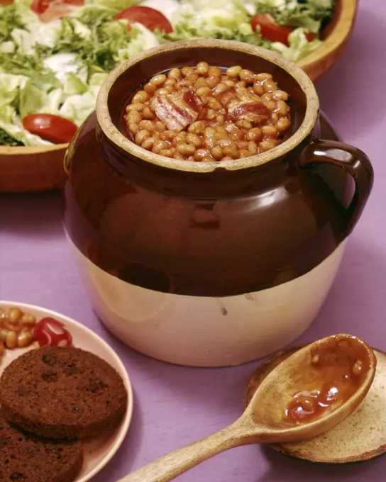 1950s COMFORT FOOD BOSTON BAKED BEANS IN BROWN CROCK WITH ROUND BROWN BREAD AND SALAD