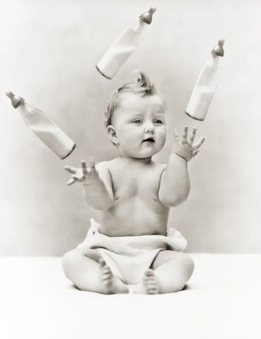 1930s BABY WEARING CLOTH DIAPER SITTING JUGGLING THREE GLASS BABY BOTTLES OF MILK