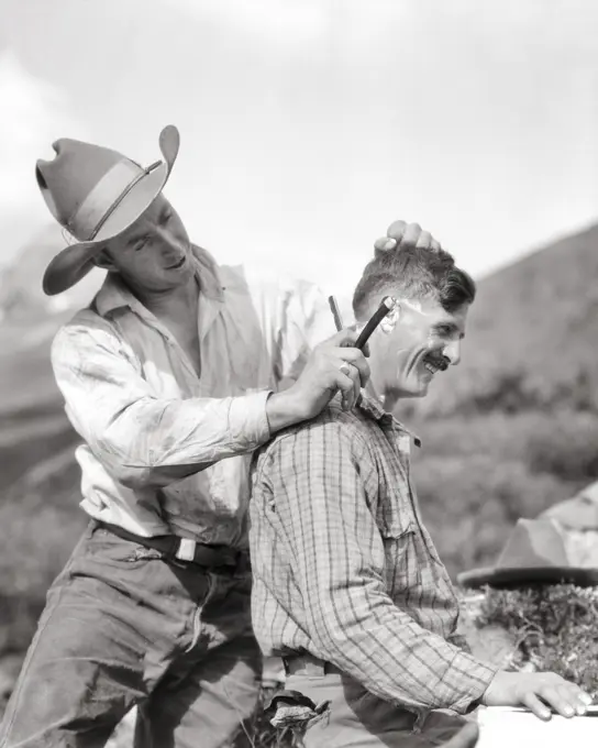 1920s WESTERN DUDE RANCH TRAIL RIDE COWBOY GUIDES ONE TRIMMING HAIR OF OTHER WITH STRAIGHT RAZOR BAKER LAKE ALBERTA CANADA