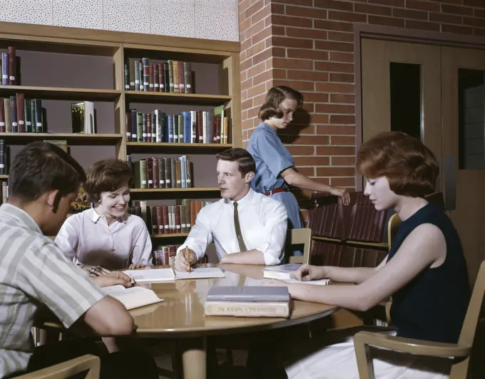 1960S 5 Students Round Table In Library High School Study Teens Boys Girls Group