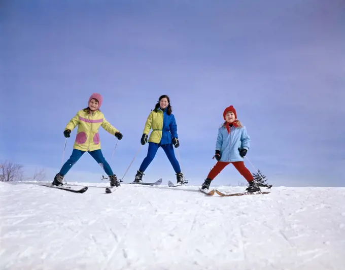1960S Mother And Two Daughters Skiing Together Winter Outdoor 