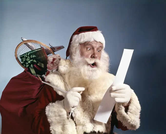 1950S 1960S 1970'S Surprised Santa Claus Carrying Sack Of Toys Reading List Studio Indoor