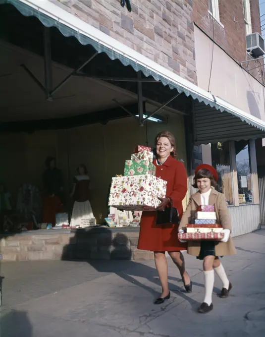 1970S Mother And Daughter Carrying Stacks Of Gift Packages