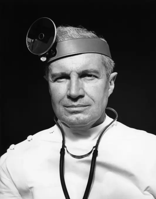 1940S Portrait Of Senior Doctor Wearing Opthalmoscope And Stethoscope