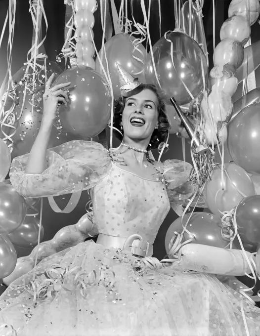 1950S Woman In Party Dress Surrounded By Streamers & Balloons