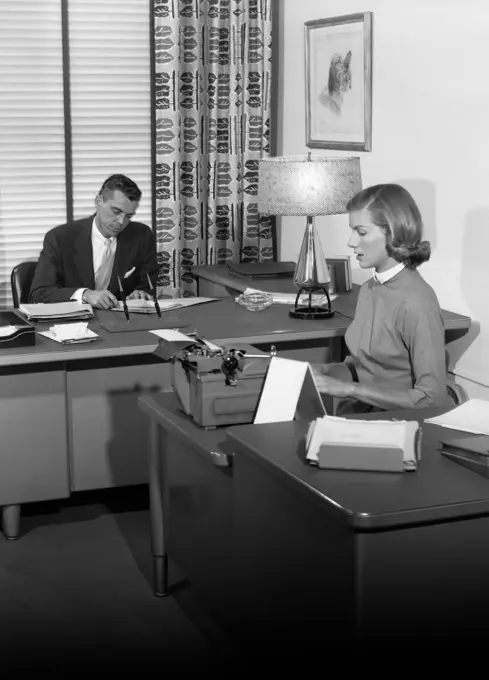 1950S Office With Executive At Desk And Secretary Typing