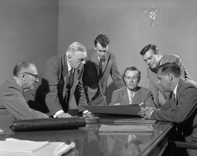 1950S Group Of Six Men Around A Chart