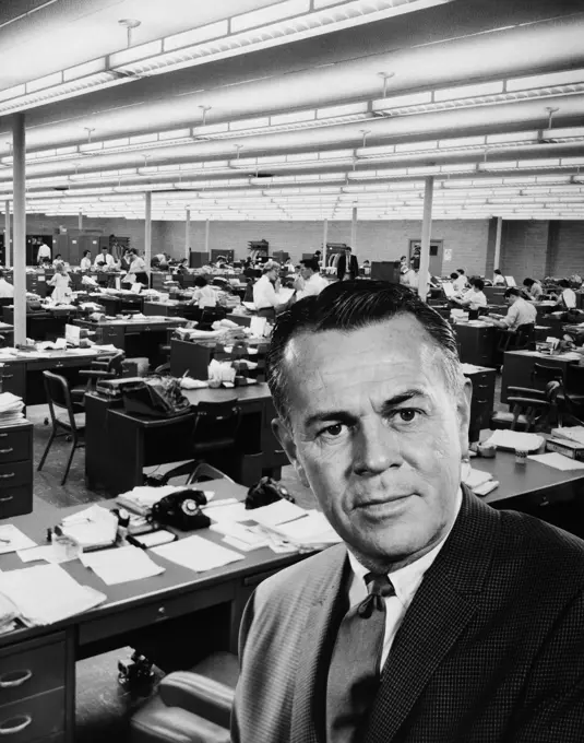 1960S Portrait Of Executive Superimposed Over Busy Office Background