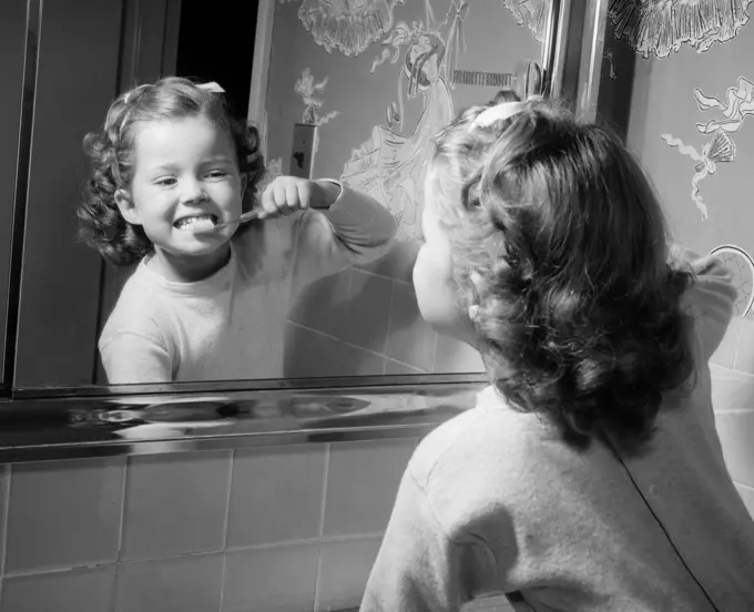 1950S Girl Looking In Bathroom Mirror Brushing Teeth