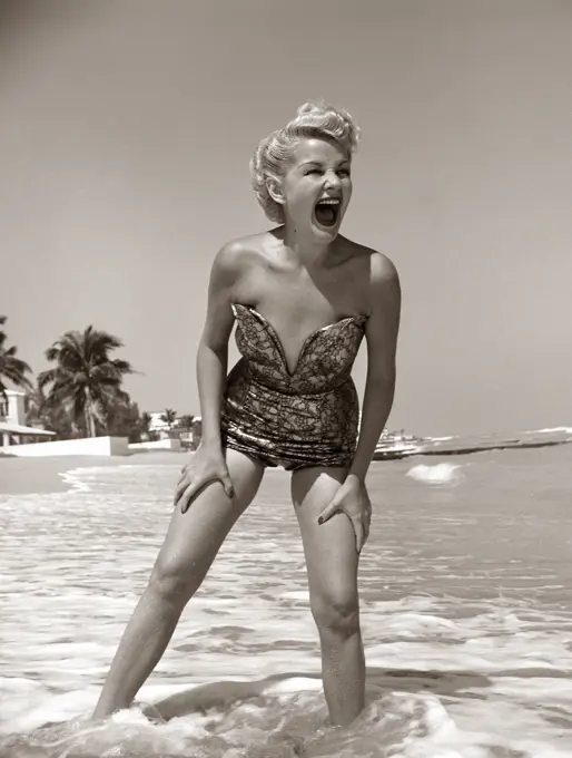 1950S Laughing Blonde Woman In Strapless Low Cut Bathing Suit Swim Wear Wading Up To Ankles In Surf