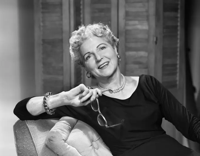 1950S Smiling Fashionable Senior Woman Holding Glasses Wearing Bracelet