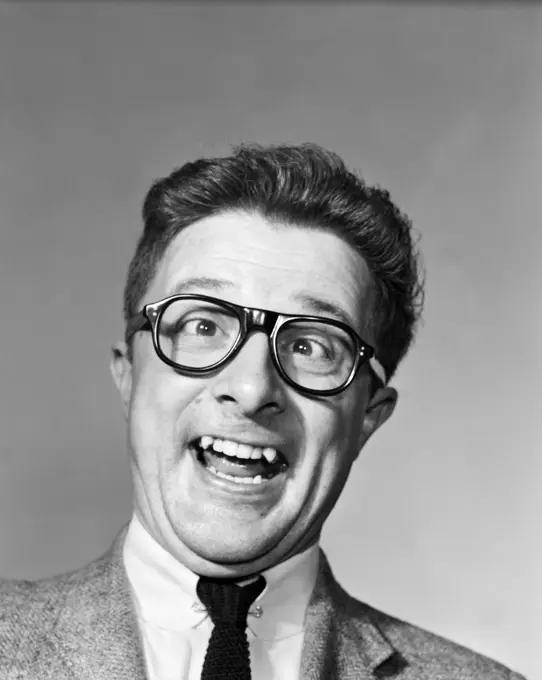 1960S Man Wearing Black Plastic Frame Eye Glasses Making A Goofy Expression